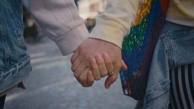 Hands of two lesbian women holding each other. Lgbt couple, holding hands, touch each other, feeling love when they are together. Close up. Woman relationships, lgbt concept.