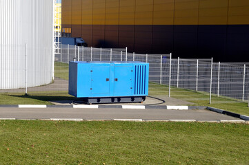 New blue mobile diesel generator for emergency power supply of the production complex.