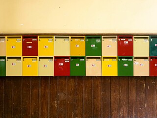Colorful letter boxes on the wooden wall