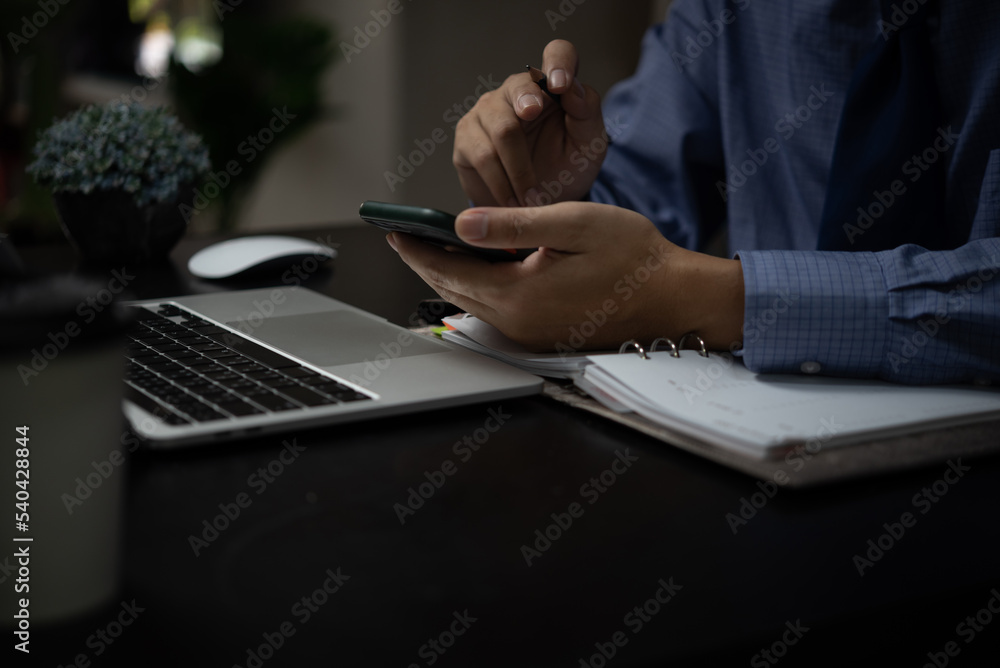 Aufkleber business man working on laptop computer and using mobile phone on desk digital technology concept.