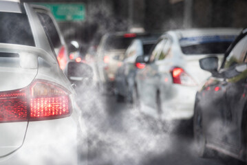 Air pollution from car exhaust smoke traffic in the city. Reducing global warming pollution and...