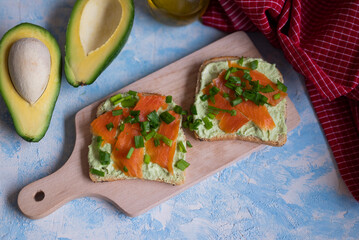delicious toasts with avocado paste and salmon