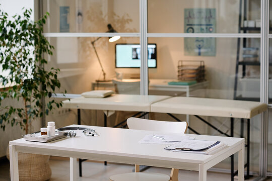 Horizontal image of modern office of pediatrician with workplace with documents on it