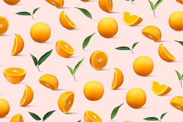 Fresh yellow oranges with green leaves, pattern, on pink background. Full Depth of field. Clipping path