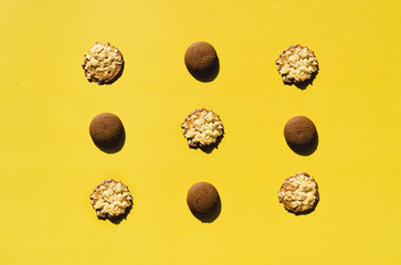 Sweet homemade brown cookies on yellow background. Biscuit,  pastry. Top view, copy space, mockup. Flat lay. Food and drink.