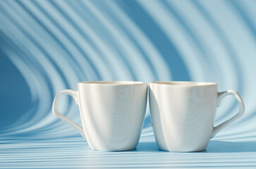 Cups of hot black coffee, tea on blue background. Top view, copy space, mockup. Flat lay. Modern breakfast food.