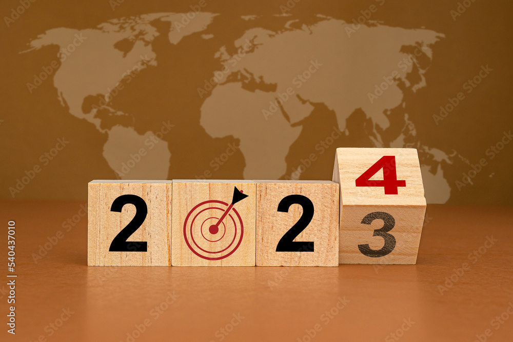 Poster countdown and business planning in 2024. wooden cubes with the letters 2024 on a table with the worl