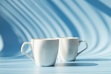 Cups of hot black coffee, tea on blue background. Top view, copy space, mockup. Flat lay. Modern breakfast food.