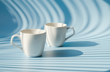 Cups of hot black coffee, tea on blue background. Top view, copy space, mockup. Flat lay. Modern breakfast food.