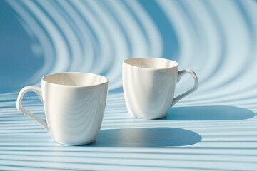 Cups of hot black coffee, tea on blue background. Top view, copy space, mockup. Flat lay. Modern breakfast food.