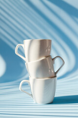 Cups of hot black coffee, tea on blue background. Top view, copy space, mockup. Flat lay. Modern breakfast food.
