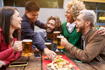Group Of Friends Enjoying Evening Drinks and food In Bar. Happy people laughing. High quality photo