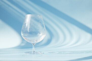 A glass of water on blue background. Top view, copy space, mockup. Flat lay. Healthy lifestyle. Food and drink