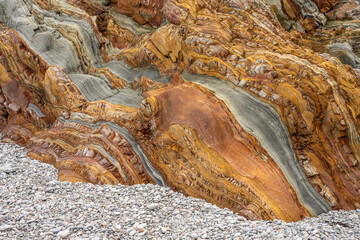 Natural rock texture of a colorful rock formations in silence beach (playa del Silencio) in Asturias, north of Spain.