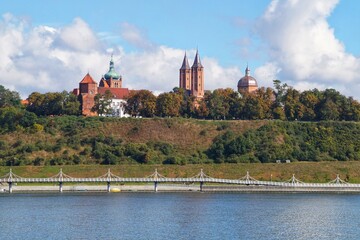 View of the castle and the cathedral on the Tum hill in Płock from the other side of the Vistula river. - obrazy, fototapety, plakaty