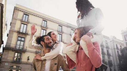 Slow motion of a Two beautiful European couples in piggyback laughing and having fun. Friendship concept . High quality photo - Powered by Adobe