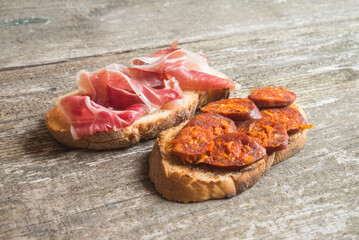 bread toast with chorizo and ham (spanish tapa)