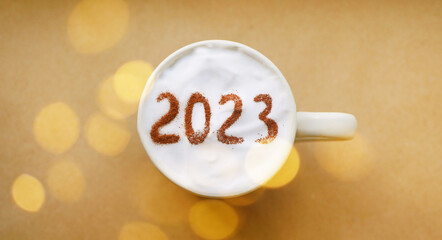 Cup of coffee with 2023. New Year banner. Winter holidays greeting