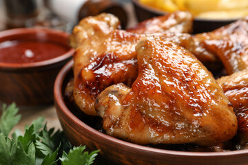 Closeup view of delicious fried chicken wings in bowl