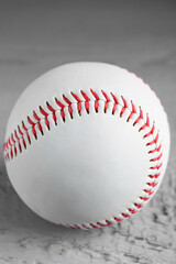 Baseball ball on grey wooden table, closeup view