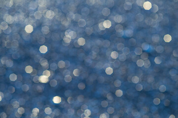 Lights on sea waves background. Blur summer sparkling sea water.