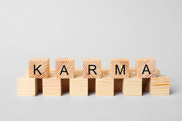 Word Karma made of cubes with letters on light background