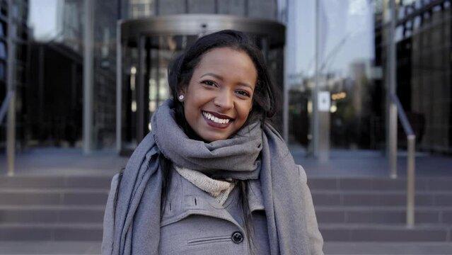 Young African American businesswoman looking camera smiling. Cheerful lady smiling for the successes of work. High quality photo