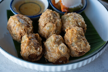 Delicious deep fried crab meat roll on the table.