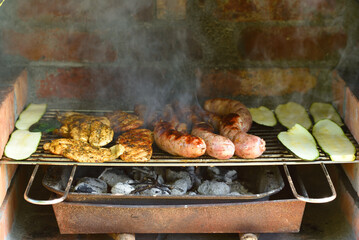 Grilling sausages and meat on a barbecue grill.