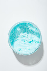 Top view of blue cream boby sutter in jar cometic products on light surface
