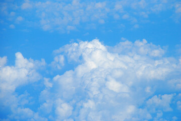 Obraz premium Blue sky fluffy white clouds on summer season bright clear skyline with beautiful cloudscape. Panorama blue sky clouds pattern on daylight with copy space. Cumulus cloudscape air climate sunny day