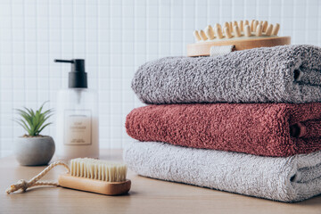 Obraz na płótnie Canvas Towels. Clean fresh fluffy towels and bath accessories on table in bathroom