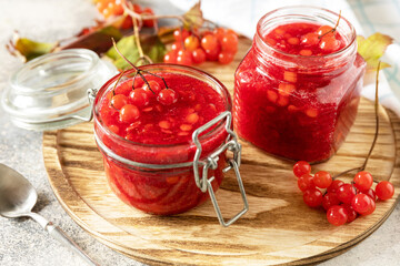 Fresh ripe viburnum berry with sugar for preparation vitamin and antioxidant tea on a stone table. Source of natural vitamins. Used in folk medicine.
