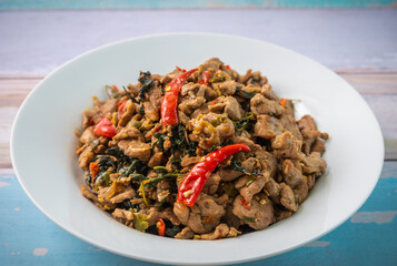Spicy fried pork with basil leaves, the famous traditional Thai food.