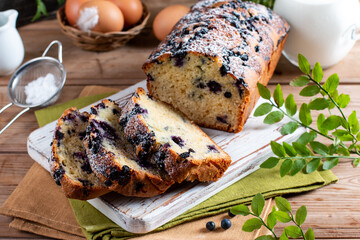 Blueberry cake with fresh berries on rustic wooden table