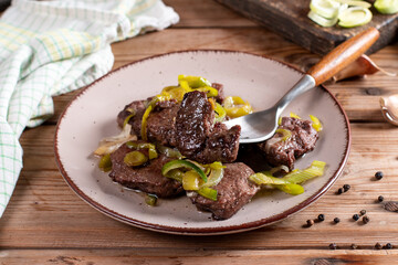 Meat medallions with leek. Pork medallions. Roasted fillet. Main course - Meat steak from pork on ceramic plate.