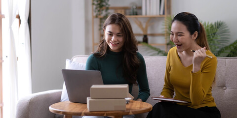 Portrait of Starting small businesses SME owners, two Asian woman check online orders Selling products working with boxs freelance work at home office, sme business online small medium enterprise
