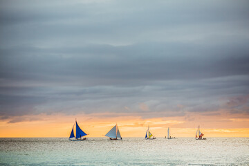 Sailing boat to the sunset in Boracay island on Philippines