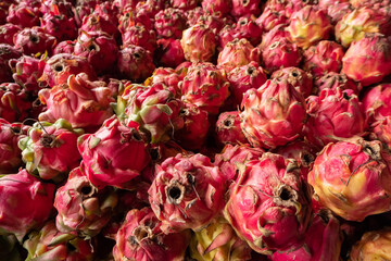 pile of fresh dragon fruit for sale, soft focus