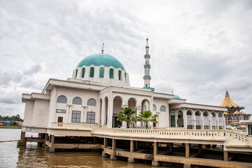Fototapeta na wymiar the view of Sarawak river and India Mosque Kuching in Kuching Sarawak Malaysia. Kuching’s one and only floating mosque situated by the Waterfront got its unique design.