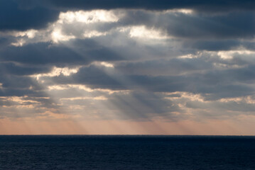 Naklejka na ściany i meble Sunset Sunlight Through Clouds Over Caribbean