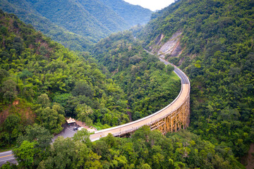 Fototapeta premium Top view Aerial photo from flying drone over The highest bridge pier Phor Khun Pha Muang Bridge (Huai Tong at Phetchaboon Thailand.Bridge over the jungle.Bridge over mountain and green forest