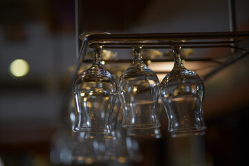 Hanging above the bar fruits juice glasses.
