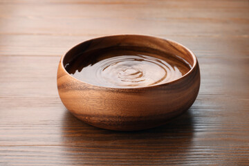 Bowl with pure water on wooden table