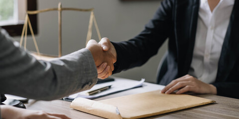 Closeup businesswoman Shaking hands with lawyer after discussing good deal in office