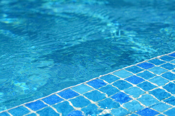 Fototapeta na wymiar Clear refreshing water in swimming pool on sunny day, closeup