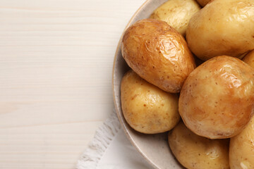 Delicious baked potatoes on white wooden table, top view. Space for text
