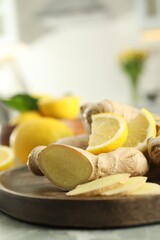 Fresh lemon and ginger on grey table, closeup. Space for text