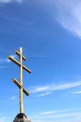 golden cross on a blue sky background