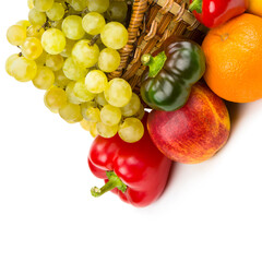 Fruits and vegetables in a wicker basket isolated on white . There is free space for text.